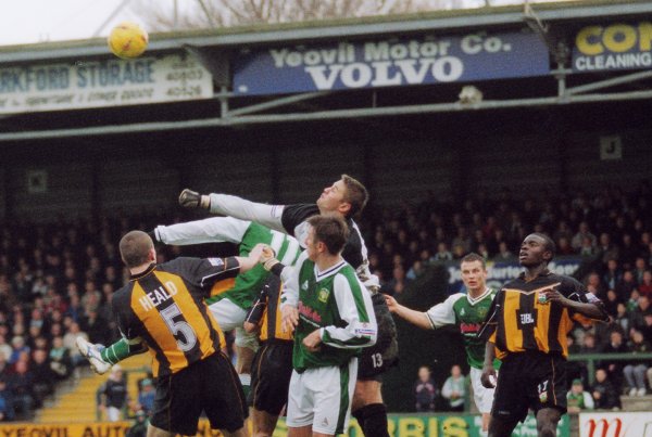 Barnet's Danny Naisbitt punches the ball clear of Kirk Jackson and Michael McIndoe
