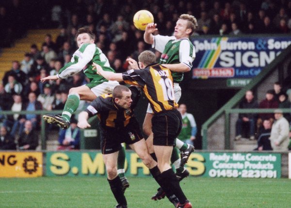Kirk Jackson gets in a flying header, with Terry Skiverton in the thick of things
