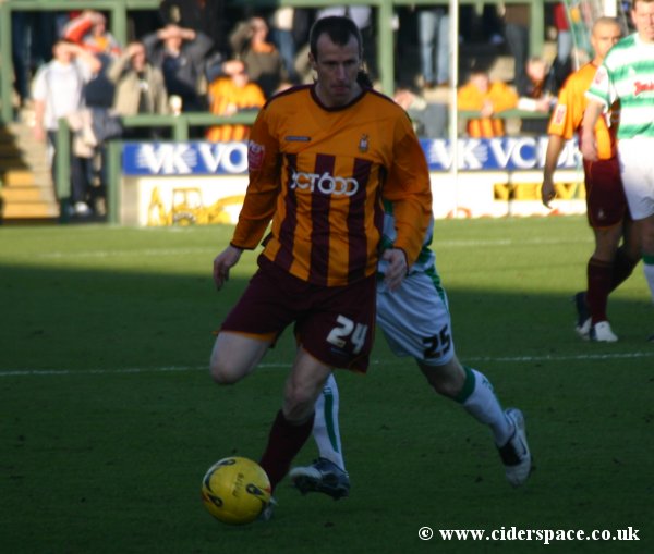 Bradford's Steve Claridge shields the ball from Arron Davies