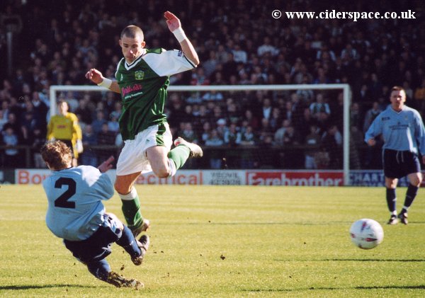 Michael McIndoe evades a strong challenge from Burscough's Jeff Underwood