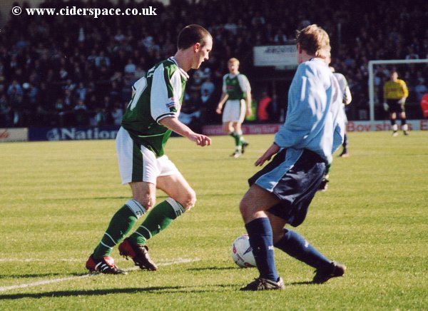 Gavin Williams finds his run checked by a Burscough player