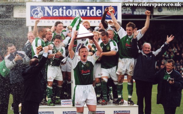 The champagne starts to be popped as the team begin to party
