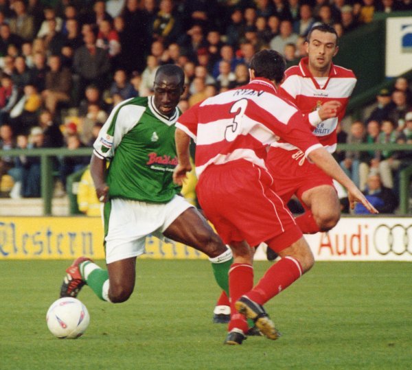 Abdoulai Demba looks to get past Doncaster's Tim Ryan