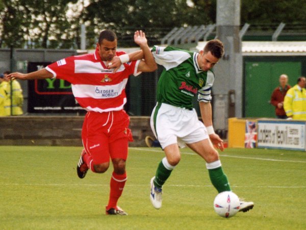 Michael McIndoe holds off a Doncaster player