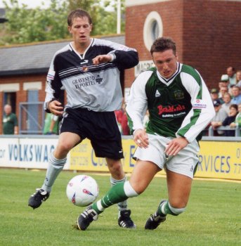 Carl Alford gets floored by a Gravesend defender