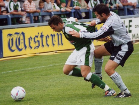 Nick Crittenden struggles to reach the ball as he starts to lose his shirt