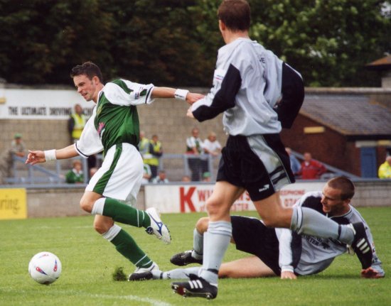 Michael McIndoe is thwarted in his tracks as a Gravesend defender trips him up