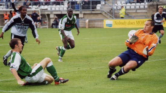 Gavin Williams beats the Gravesend keeper with his narrow angle shot, but the ball goes wide of goal