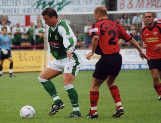 Carl Alford steers clear of Poppies defender Martin Matthews