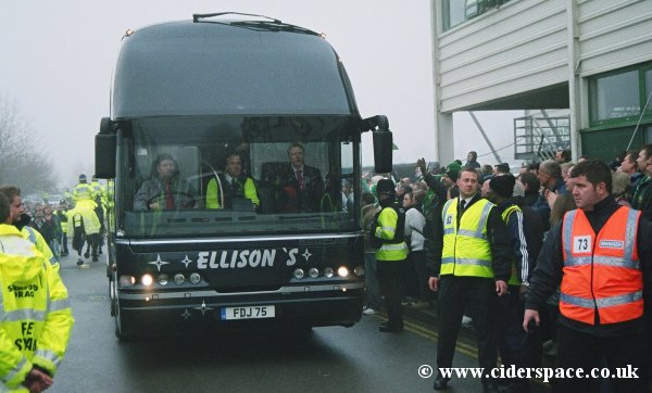 The coach pulls up amongst crowds of supporters