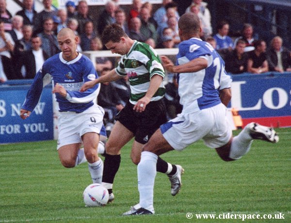 Kevin Gall tries to squeeze between two Macclesfield defenders