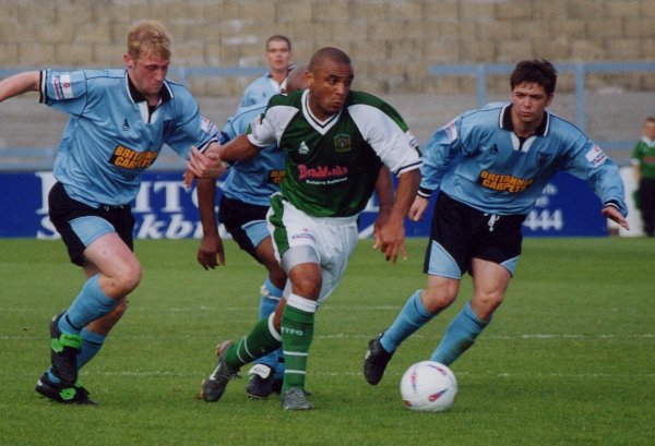 Kim Grant finds a clutch of Vics defenders chasing him for the ball