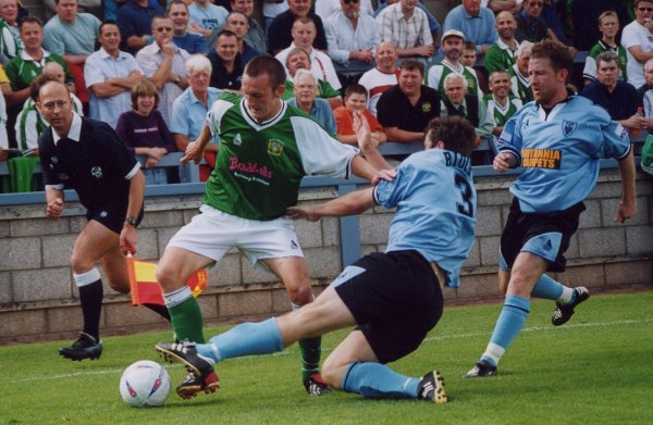 Gavin Williams and Gregor Rioch slide in to claim the ball
