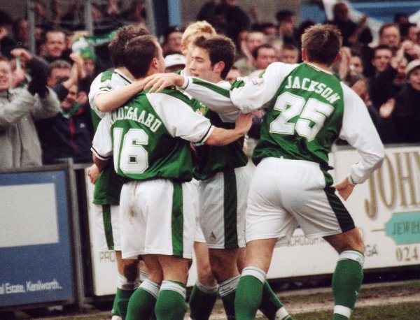 Andy Lindegaard is mobbed by his team-mates following his goal at Nuneaton