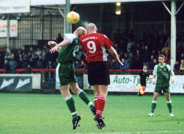 Adam Lockwood goes for an aerial challenge with Neil Campbell