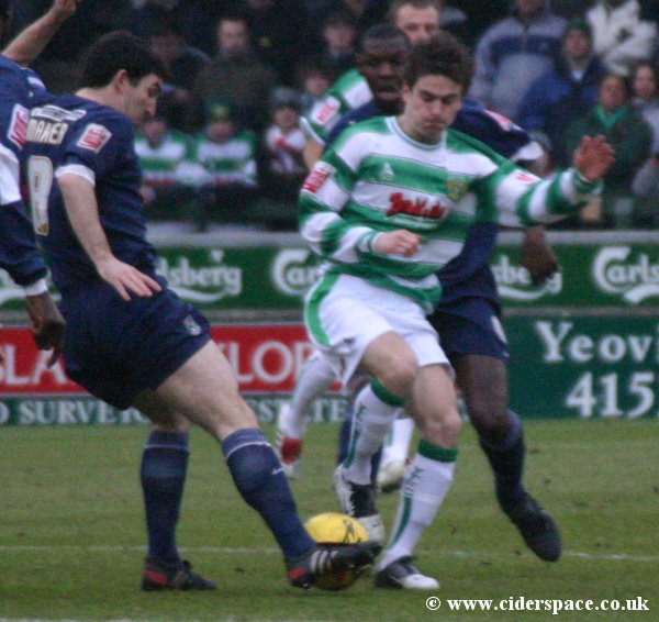 Arron Davies goes in for a tackle with Southend captain Kevin Maher