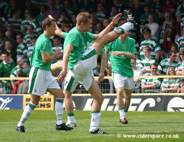 Bartosz Tarachulski joins the players doing pre-match warm-ups in front of the travelling fans