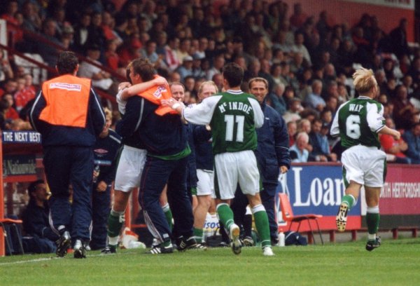 Terry Skiverton is congratulated by Carl Alford as the Yeovil dugout celebrates