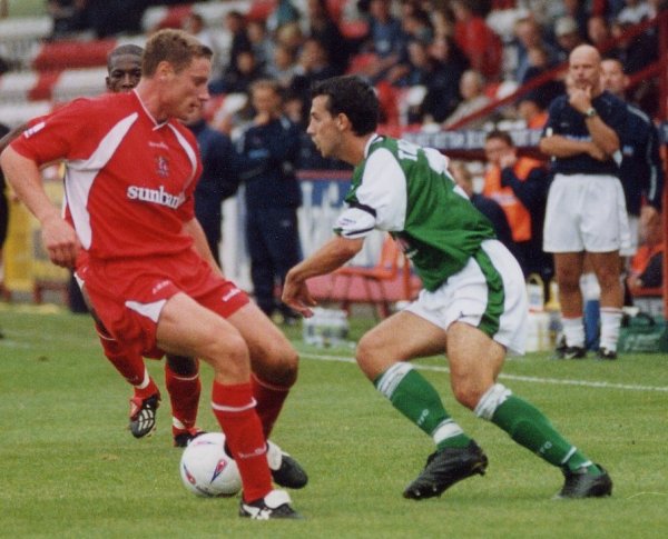 Anthony Tonkin finds himself closed down by a Stevenage midfielder