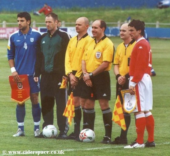 Arron Davies lines up with the Cyprus captain and match officials