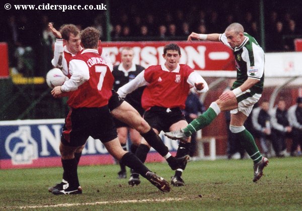 Michael McIndoe shoots through a crowd of Woking players