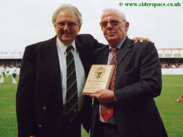Yeovil Town Chairman John Fry receives a commemorative plaque from Daggers Chairman David Andrews
