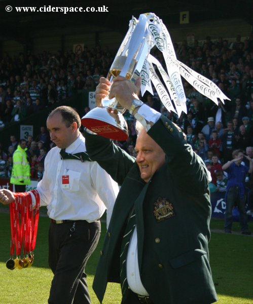Chairman John Fry takes the League Two trophy out onto the pitch