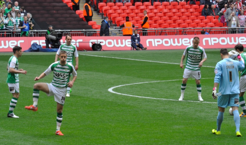 Players including Sam Foley, warm up before kick-off. Photo c/o Yeokel